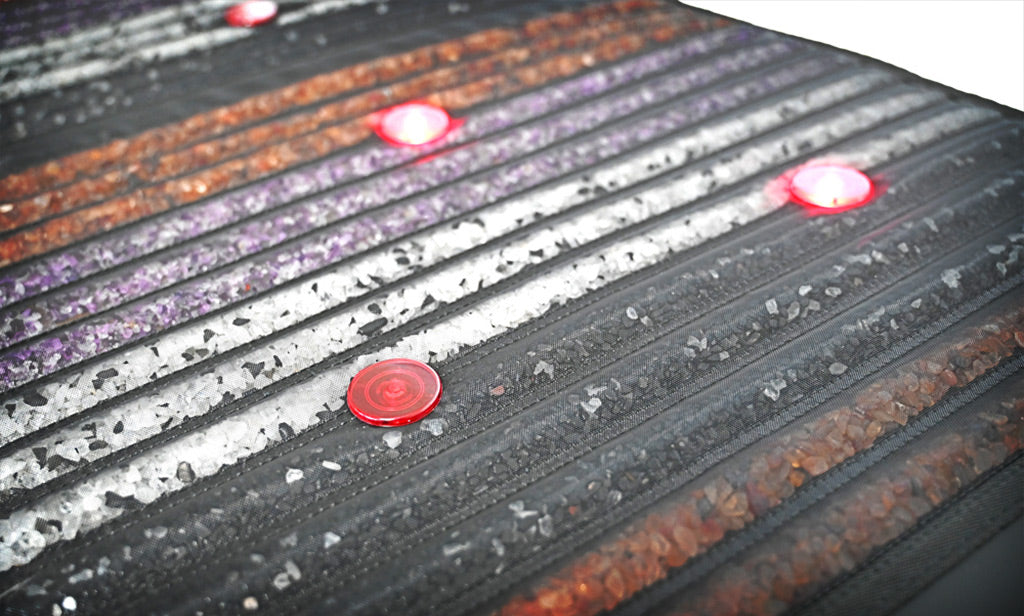 A PEMF mat with red light, infrared heat and crystals