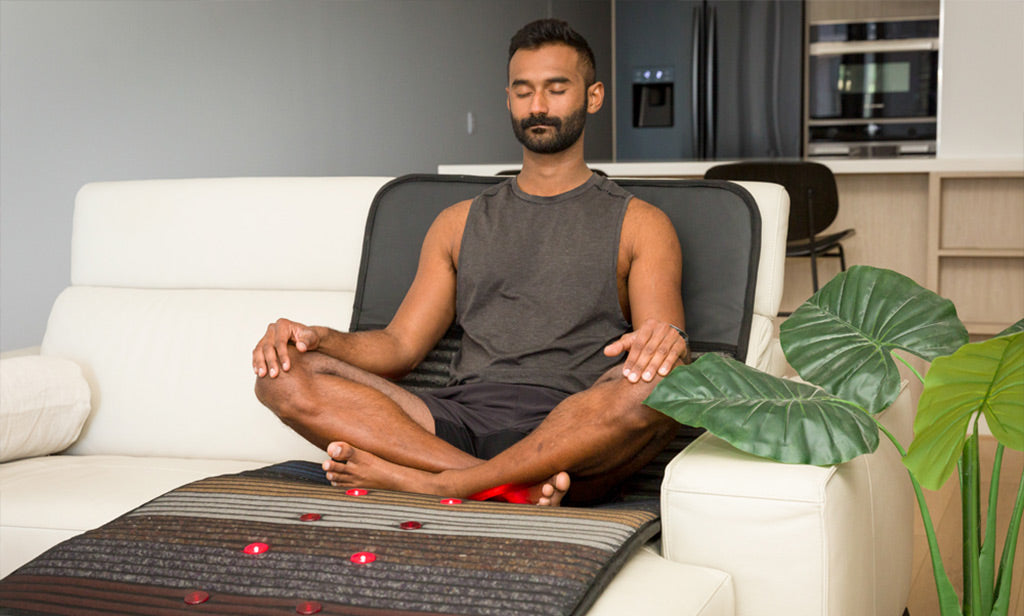 A man sat on a PEMF Mat max size