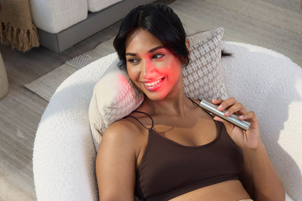 Woman Holding Bullet Red Light Therapy Device