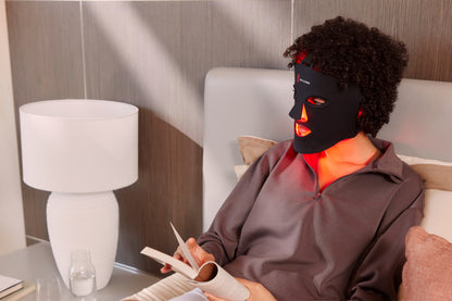 Woman Laying Down Wearing the Red Light Face Mask