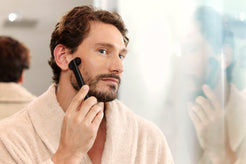Man Using Red Light Face Wand
