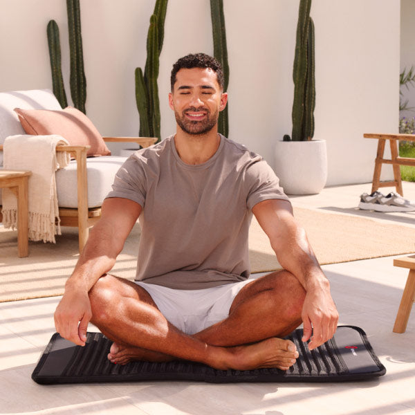 Man in Yoga Position On PEMF Mat Outside