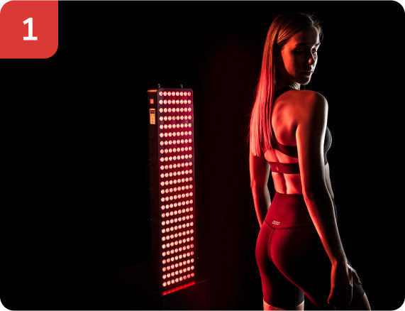 Woman stood with back to red light panel